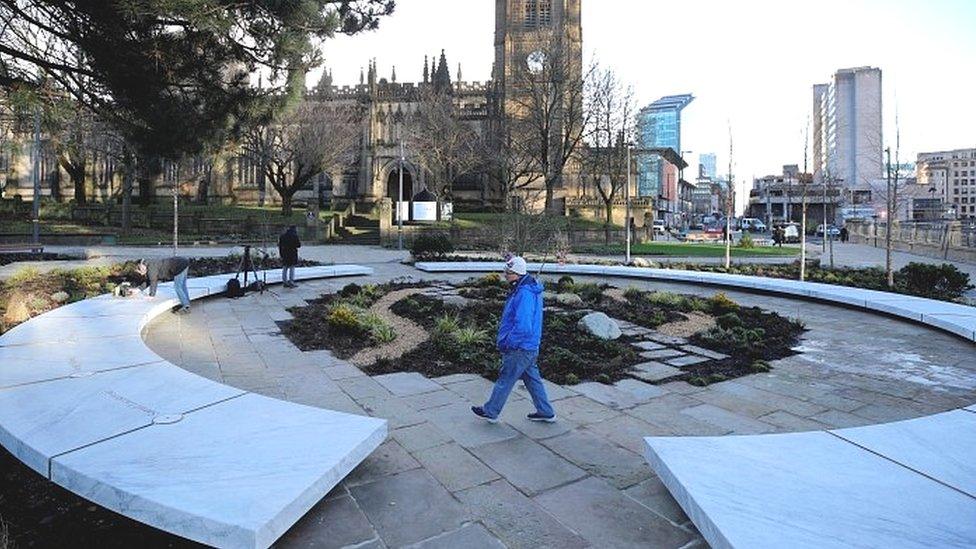 People walk around "Glade of Light" Manchester Arena attack memorial