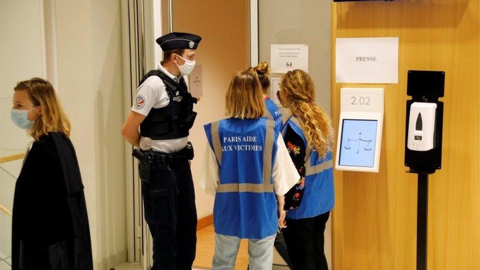 Police and employees stand near the courtroom for the opening of the trial of the January 2015 Paris attacks against Charlie Hebdo satirical weekly, a policewoman in Montrouge and the Hyper Cacher kosher supermarket, at Paris courthouse, France, 2 September 2020