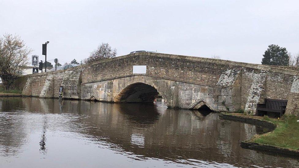 Old stone bridge showing high water level in the river