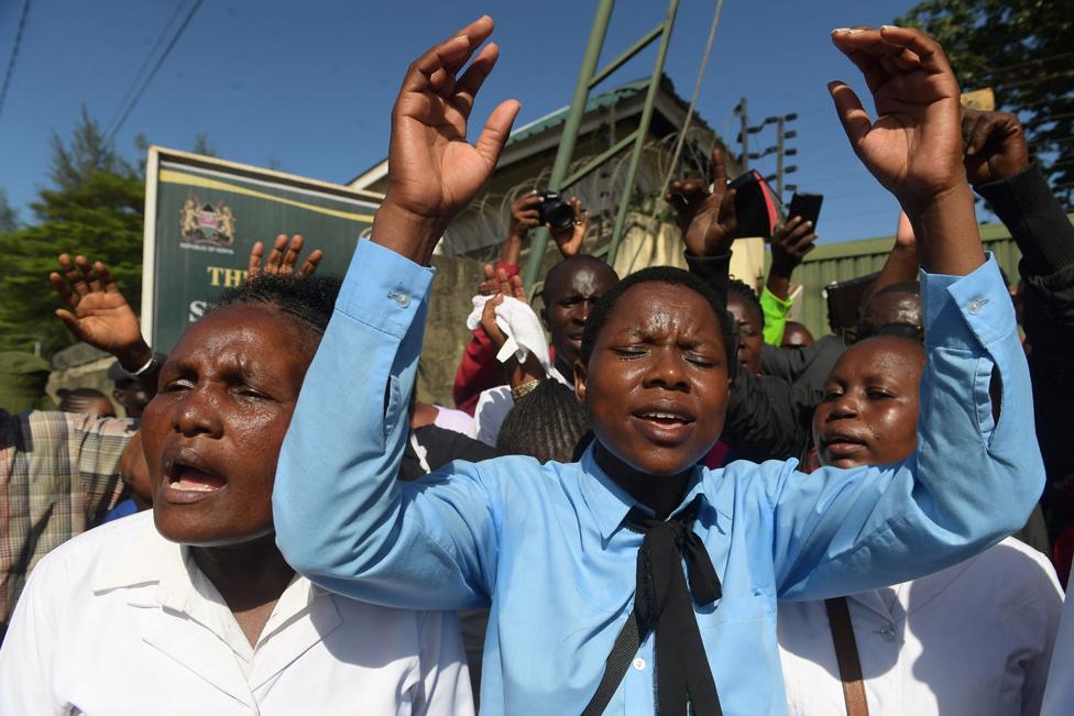 Members of the New Life Prayer Centre and Church sing and pray at the Shanzu law courts, Mombasa, Kenya