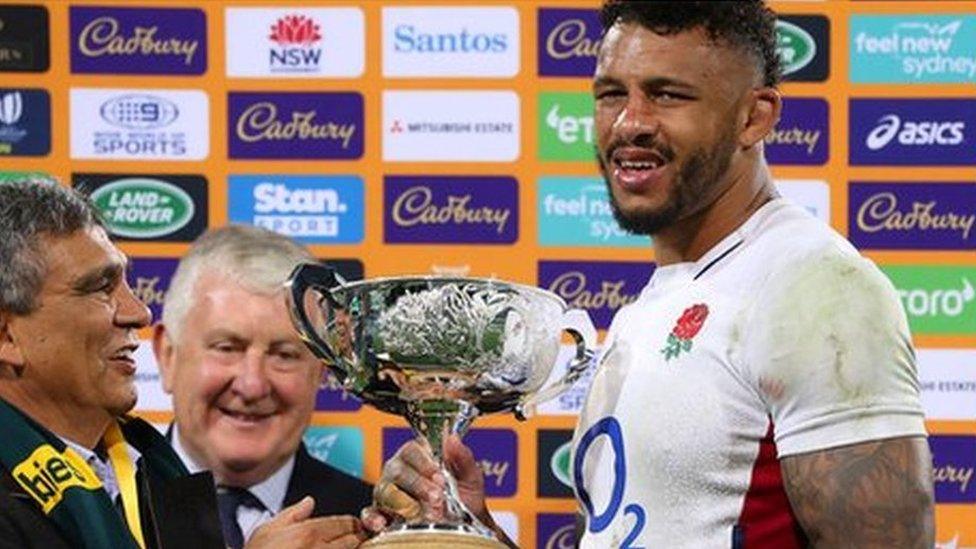 Courtney Lawes accepts silver trophy from two officials