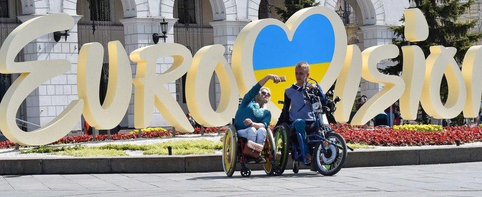 Tourists pose for selfies in Kiev