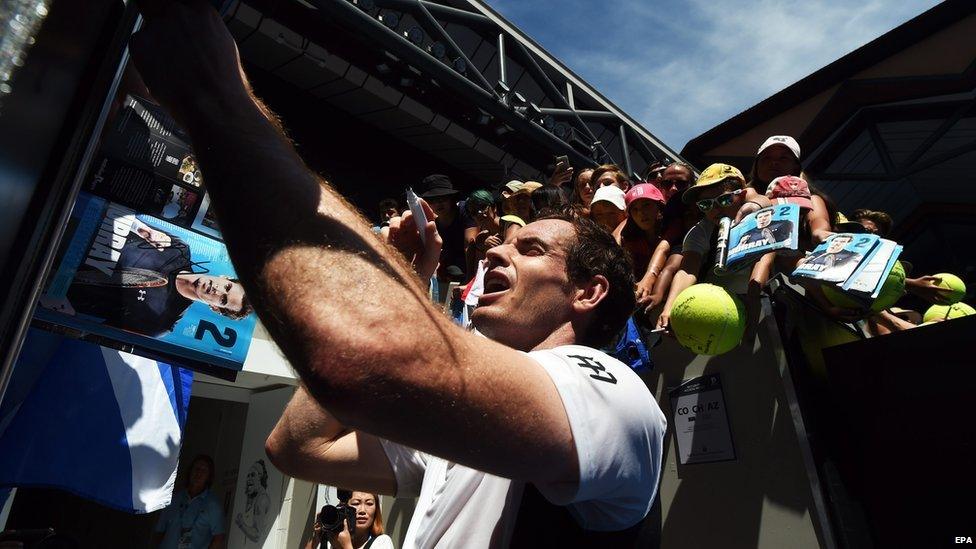 Murray signing autographs after his win