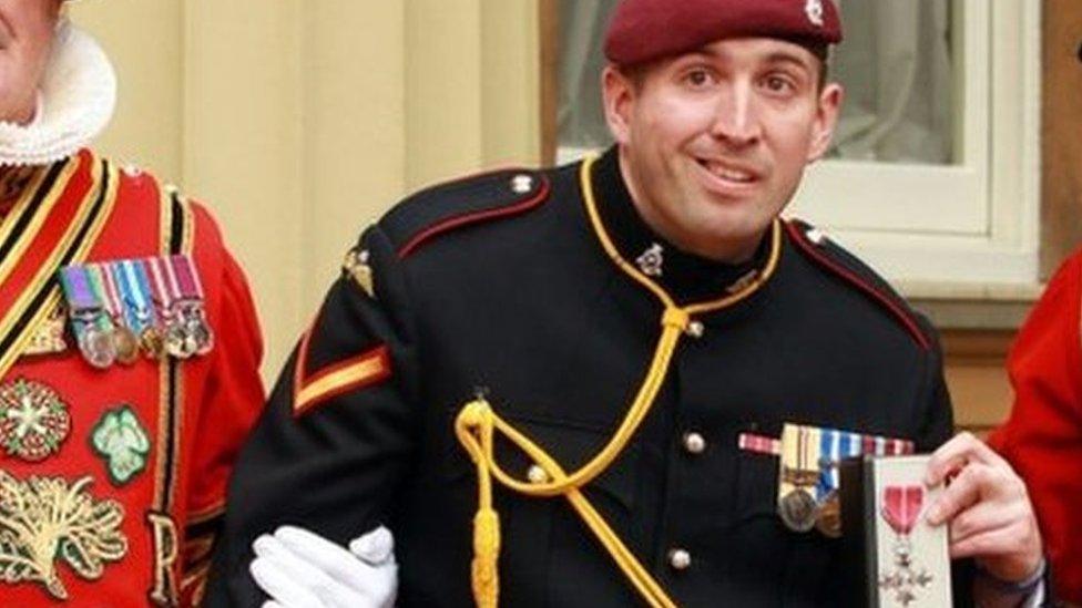 L/Bombardier Parkinson with members of the Yeoman of the Guard after receiving his MBE medal