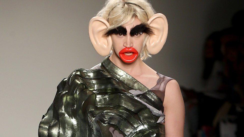 A model wearing accessories such as large ears, large lips and large eyebrows, which has been labelled 'racist'.