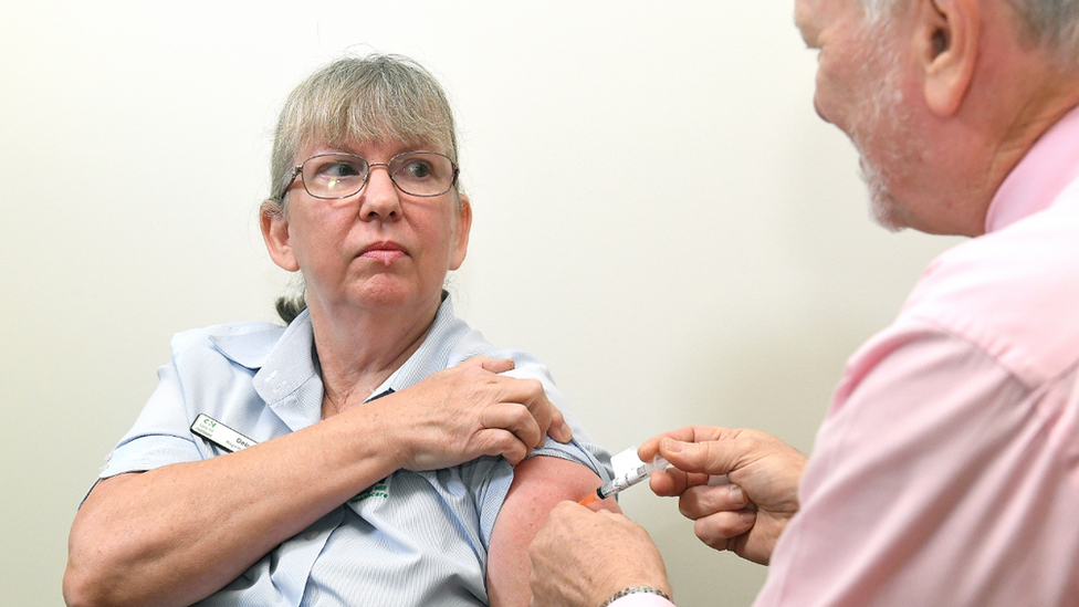 A healthcare workers gets a jab in Brisbane