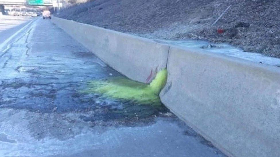 Officials closed a stretch of the highway after the liquid was seen oozing through paving