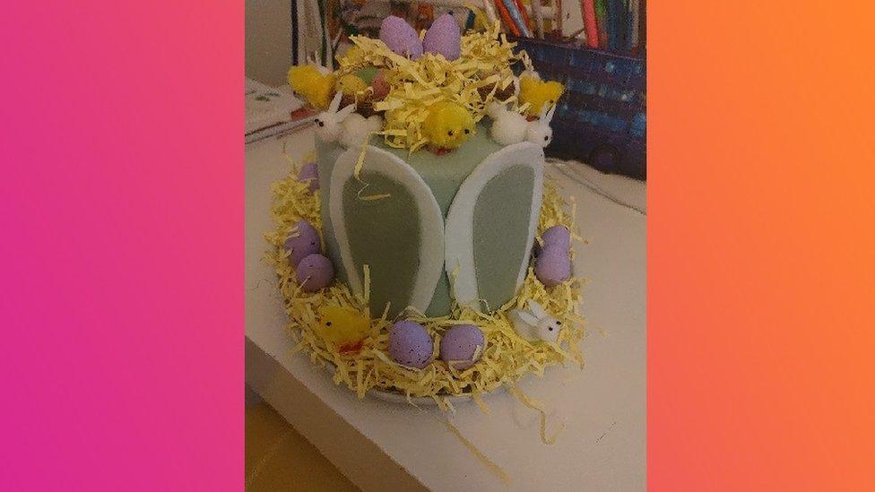 Easter bonnet with rabbit ears and eggs.