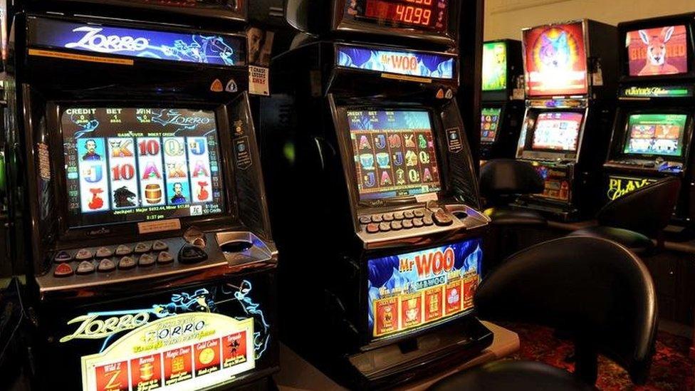 A room full of slot machines, known as poker machines or "pokies" in Australia