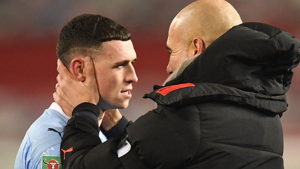 Phil Foden with Pep Guardiola.