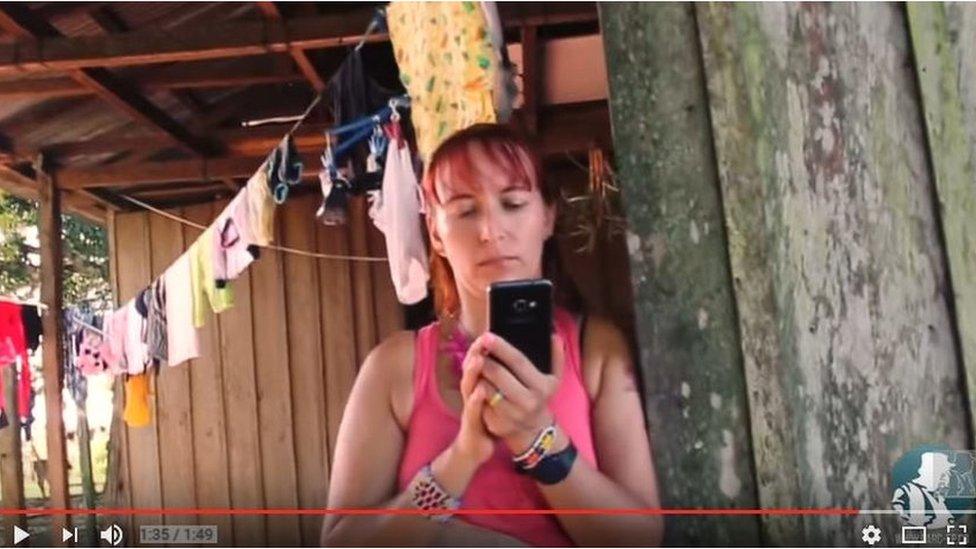 A female rebel uses a mobile phone in a Farc camp