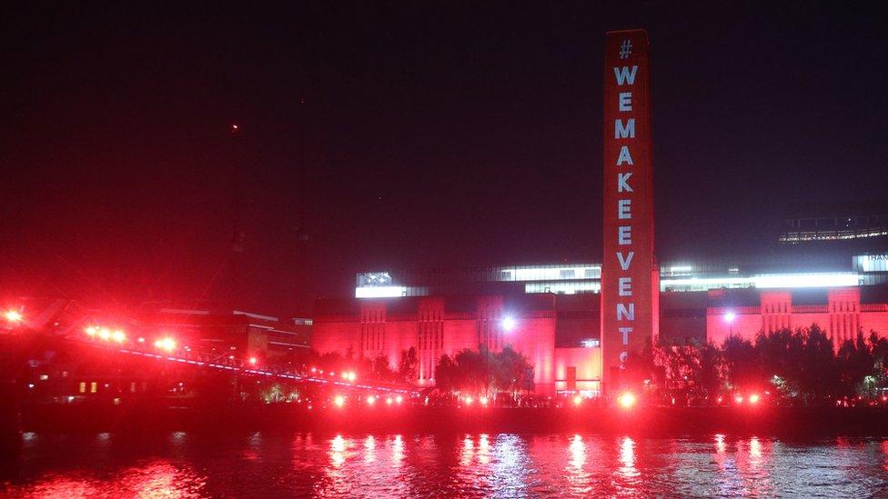 The Tate Modern and Millennium Bridge lit up in red