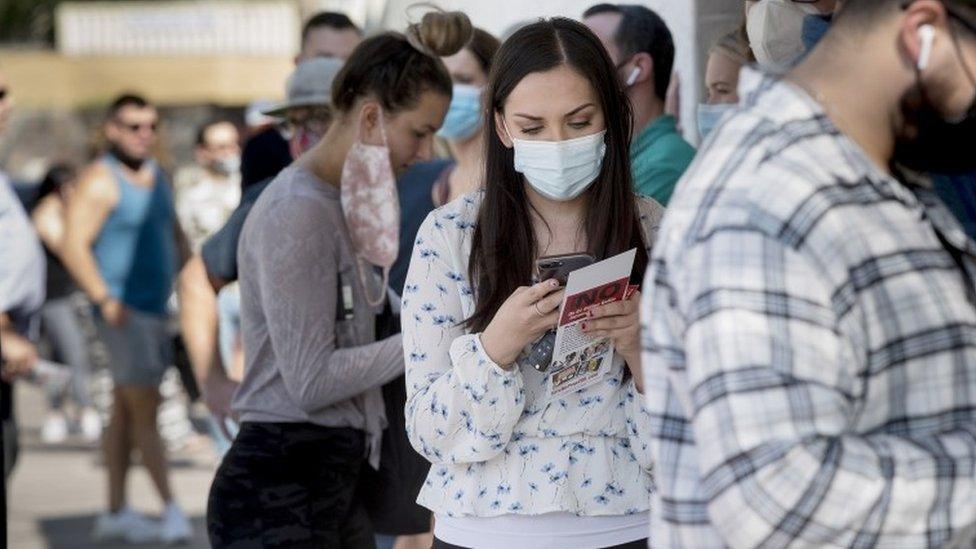 Voters wait in a line of at least 200 people at a polling location in Scottsdale, Arizona