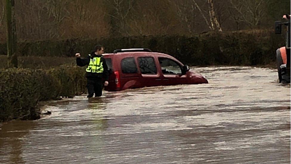 Police at flooded Cliburn Hill near Penrith