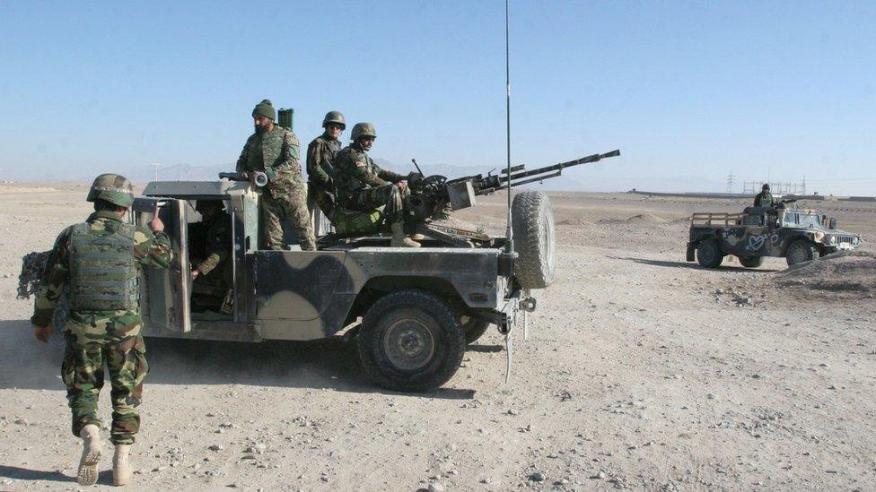 Afghan National Army soldiers guard at a checkpoint on the way to the Sangin district of Helmand province, Afghanistan, Wednesday, Dec. 23, 2015.