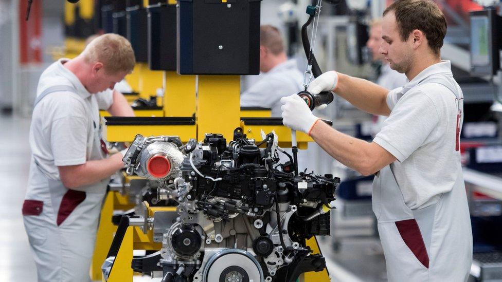 Workers at MDC Power GmbH, a company of the German Daimler AG, in Koelleda, central Germany, Friday, Oct. 23, 201