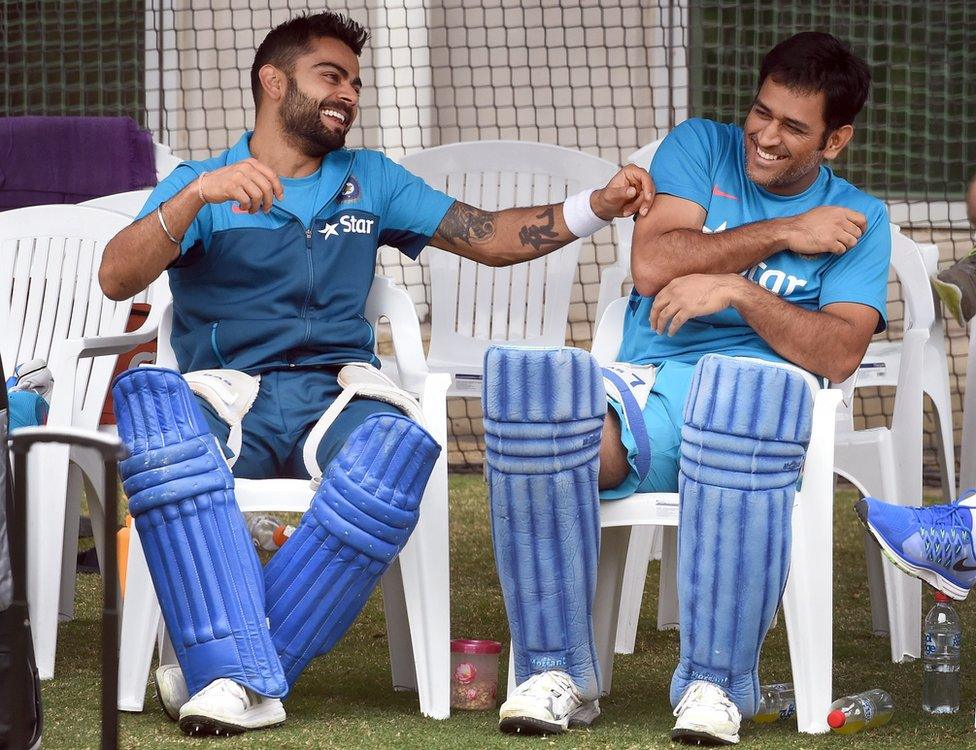 Indian cricket players Virat Kohli (L) and captain Mahendra Singh Dhoni (R) share a lighter moment during a training session ahead of their 2015 Cricket World Cup quarter-final match against Bangladesh in Melbourne on March 18, 2015.