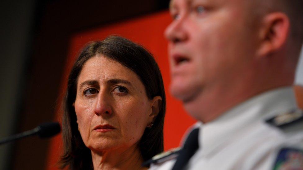 New South Wales Premier Gladys Berejiklian looks on as RFS Commissioner Shane Fitzsimmons speaks to the media during a press conference at Rural Fire Service (RFS) Headquarters in Sydney, Australia, 23 January 2020.