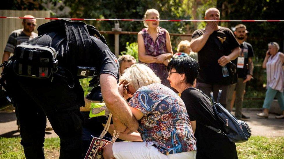 Local residents react at a site of an apartment building heavily damaged by a Russian missile strike, amid Russia's attack on Ukraine, in Kryvyi Rih, Ukraine July 31, 2023.