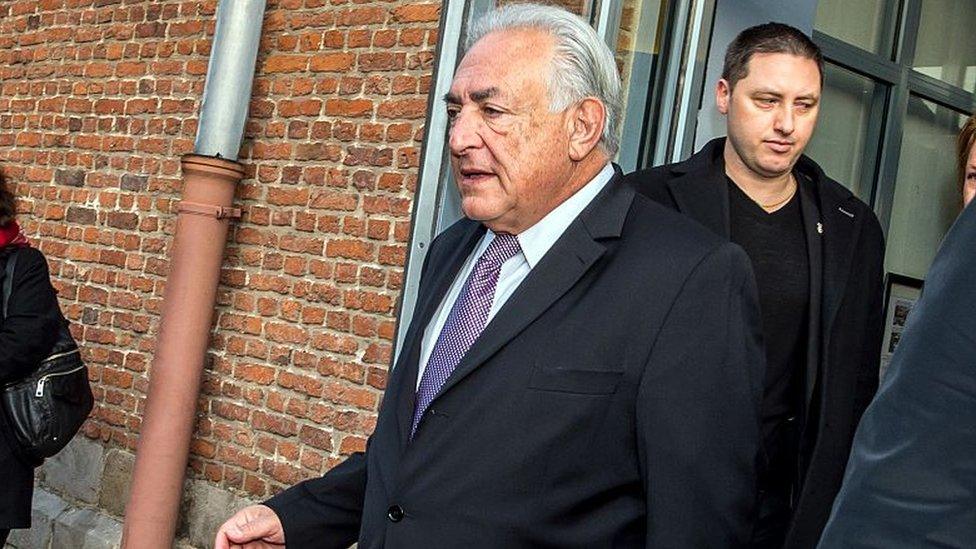 Ex-IMF chief Dominique Strauss-Kahn (C) leaves his hotel in Lille, northern France, on February 18, 2015