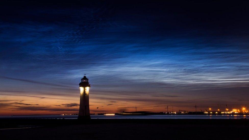 Blue night clouds above a lighthouse