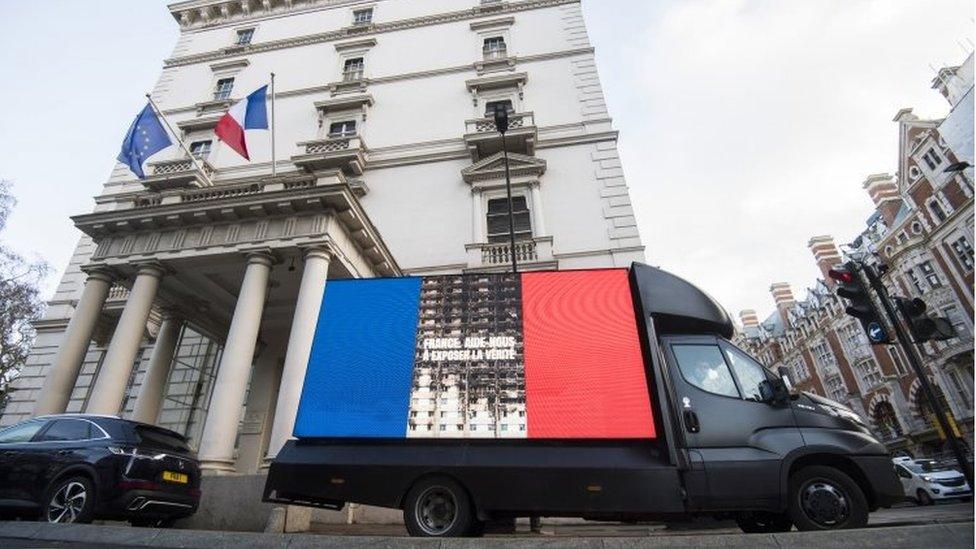 A Grenfell United campaign billboard at the French embassy in London delivering a message to the embassy urging them to demand witnesses for cladding firm Arconic residing in France to come to give evidence