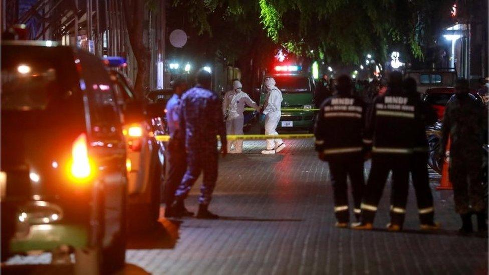 Maldives police officers stand guard outside the cordoned-off area of a blast in Male, Maldives, 08 May 2021.