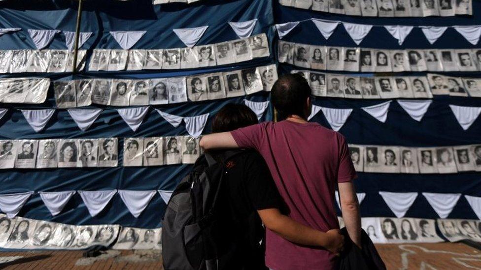 People in Buenos Aires stand next to pictures of those who went missing during Argentina's military rule. Photo: 30 April 2017