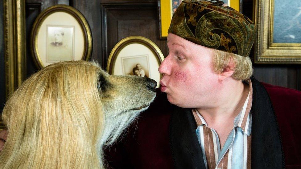 Matt Lucas puckers up with a dog as part of his BBC series Pompidou