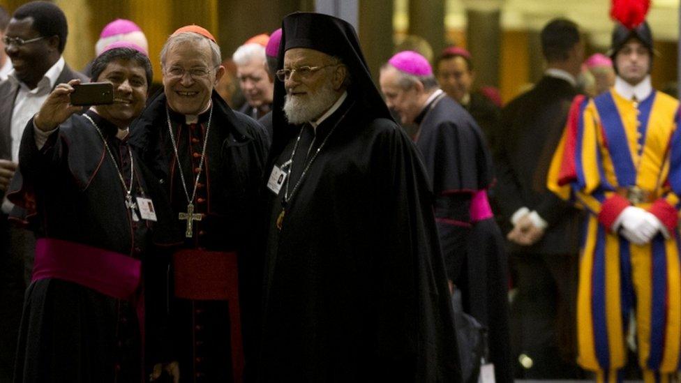 Bishops take a selfie at a meeting of the synod in the Vatican