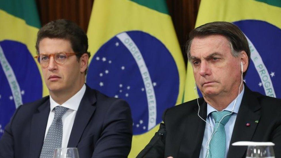 A handout photo made available by the Presidency of Brazil that shows President Jair Bolsonaro, along with the Minister of the Environment, Ricardo Salles (L), during the climate summit convened by the US President, Joe Biden, at the Planalto Palace in Brasilia, Brazil, 22 April 2021.