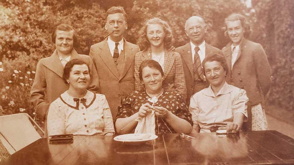 Fritz Ball (back row with pipe), Eva Ball (front row with knitting) and other refugees in Suffolk