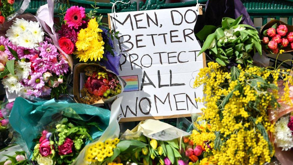 Flowers and a sign that reads "Men, Do Better. Protect All Women" in memory of Sarah Everard on Clapham Common, London, on 13 March 2021