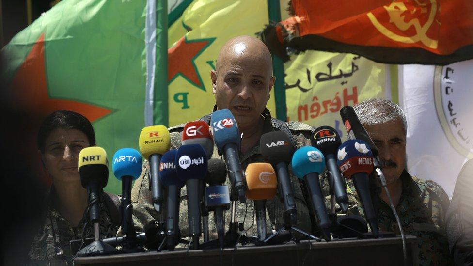 Talal Silo (C) spokesman for the Syrian Democratic Forces (SDF), speaks to reporters in the village of Hazima, Syria (6 June 2017)