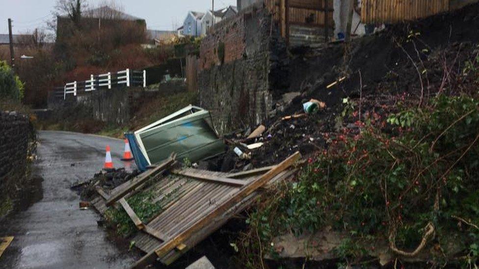 A road in Merthyr with land slip debris