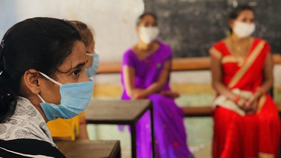 Women in rural Bihar wait to get themselves vaccinated at a public school.