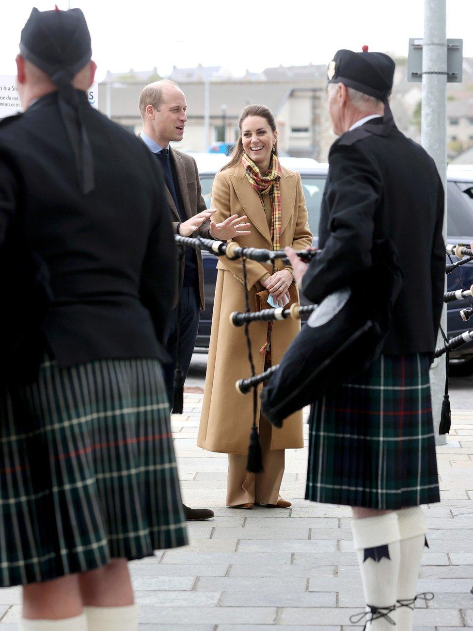 The couple speak to pipers as they arrive to open the hospital