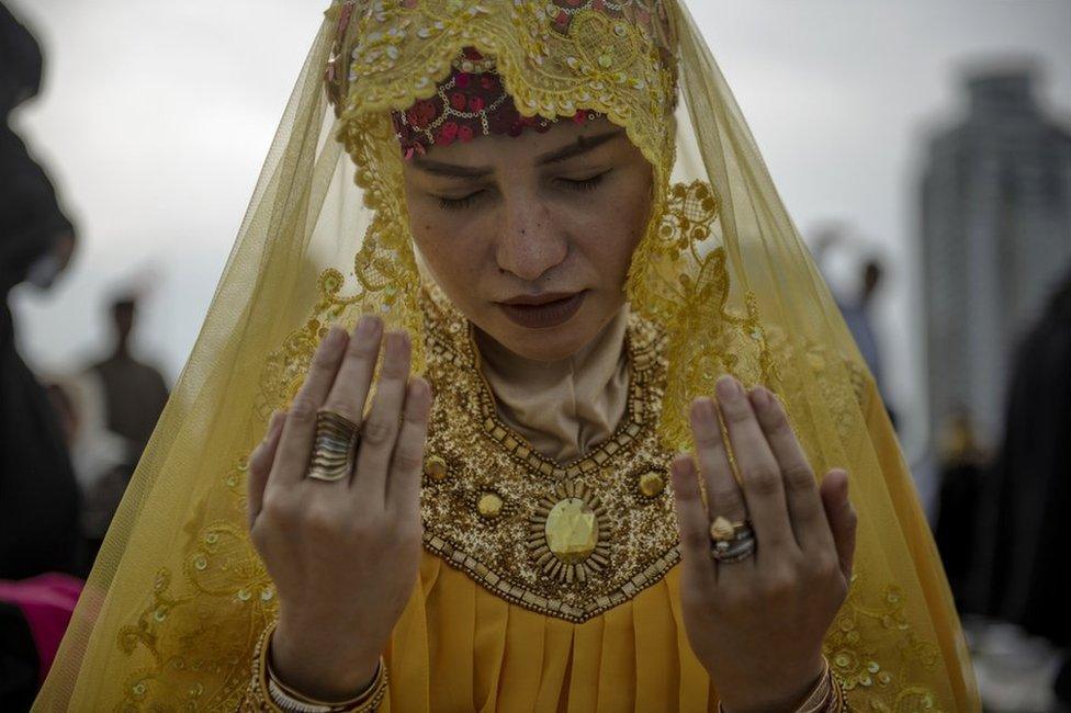 Filipino Muslim woman attends prayers in a public park to celebrate Eid al-Fitr on June 15, 2018 in Manila, Philippines