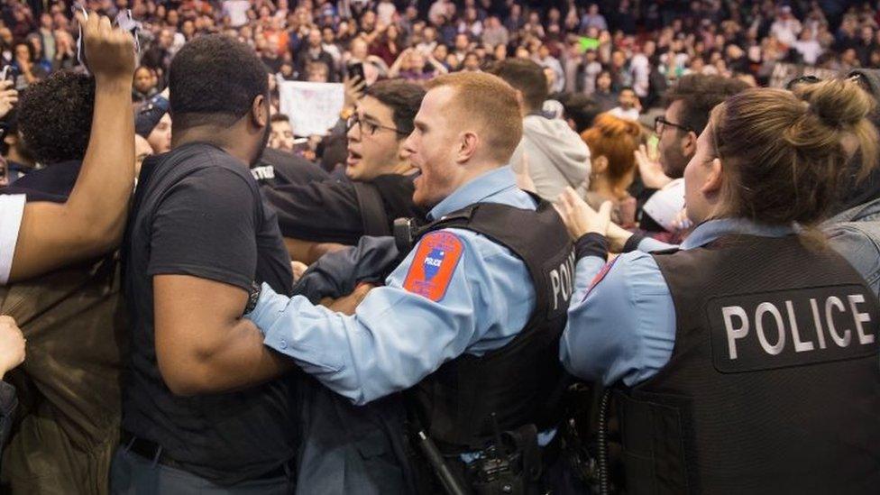 Police break up skirmishes between demonstrators and supporters of Republican presidential candidate Donald Trump that broke out after it was announced a rally at the University of Illinois at Chicago