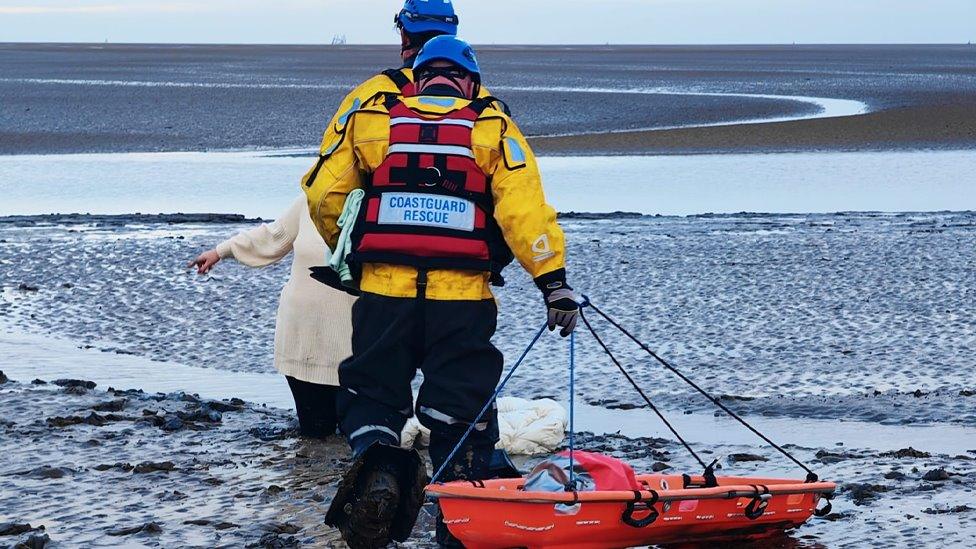 Woman being rescued from the mud