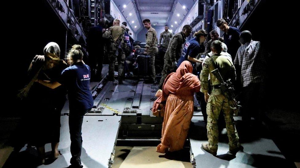 British nationals board an RAF aircraft during the evacuation to Cyprus, at Wadi Seidna airport