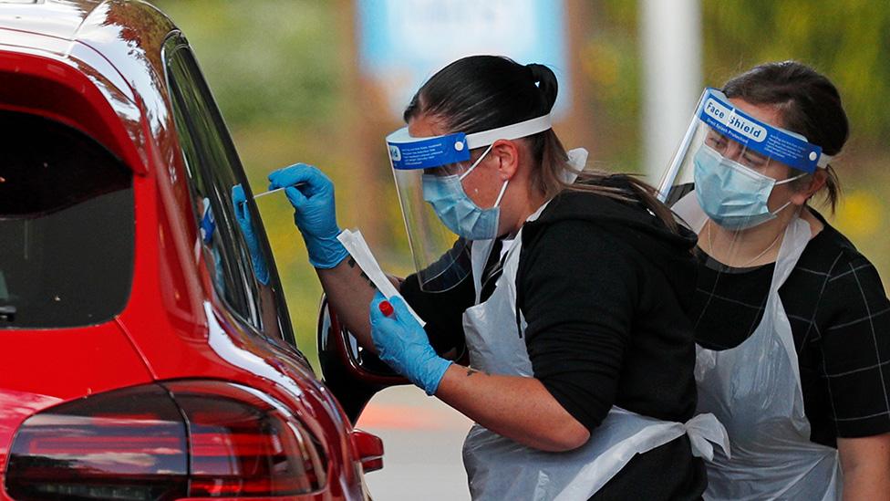 Swab testing at a drive-through coronavirus test facility