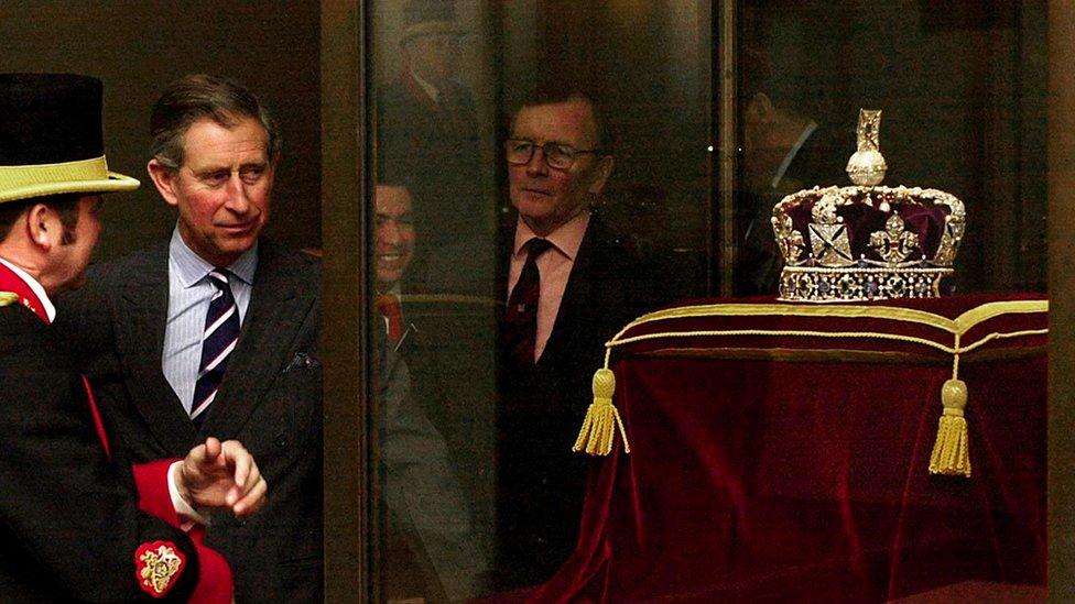 The then Prince of Wales looks at the Imperial State Crown during a visit to the Tower of London in 2003.