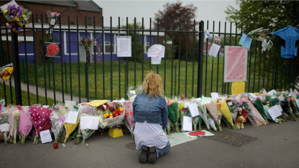 Floral tributes placed outside Corpus Christi Catholic College after teacher Ann Maguire was stabbed to death