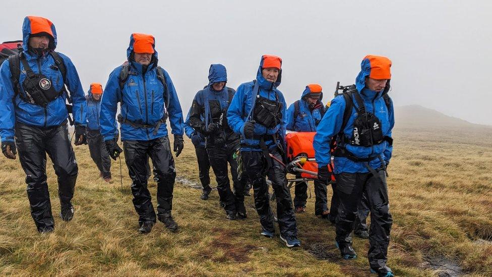 Cockermouth Mountain Rescue Team assisting a person with an ankle injury