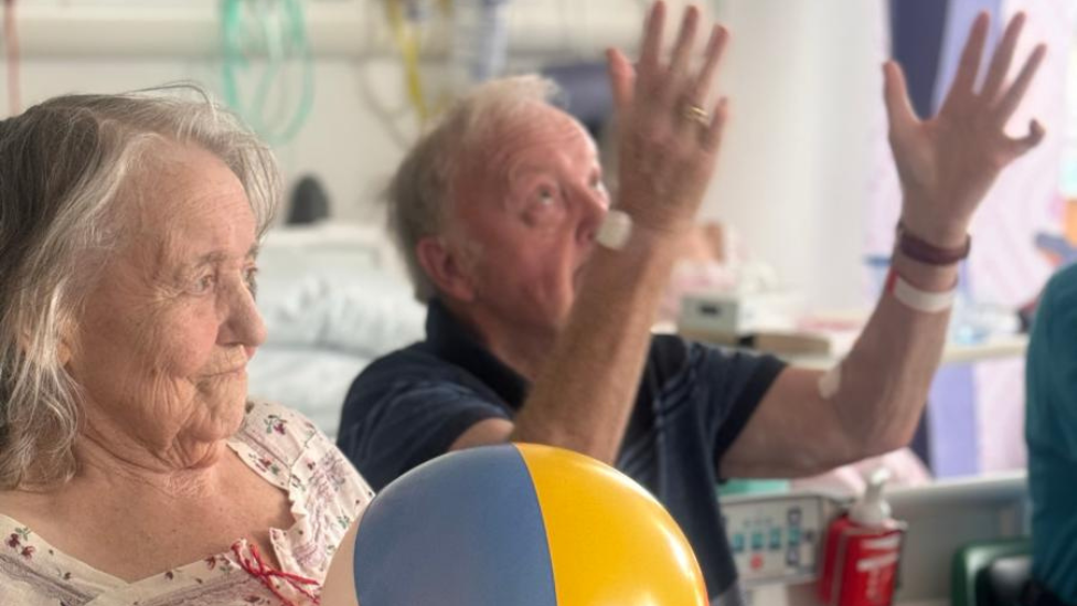 patients playing catch with a beach ball on the ward