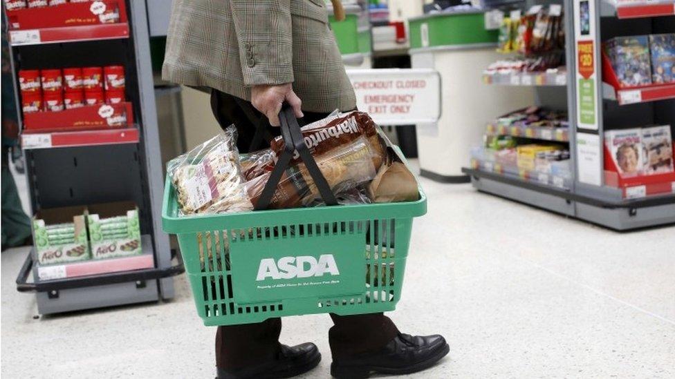 Man carrying Asda basket