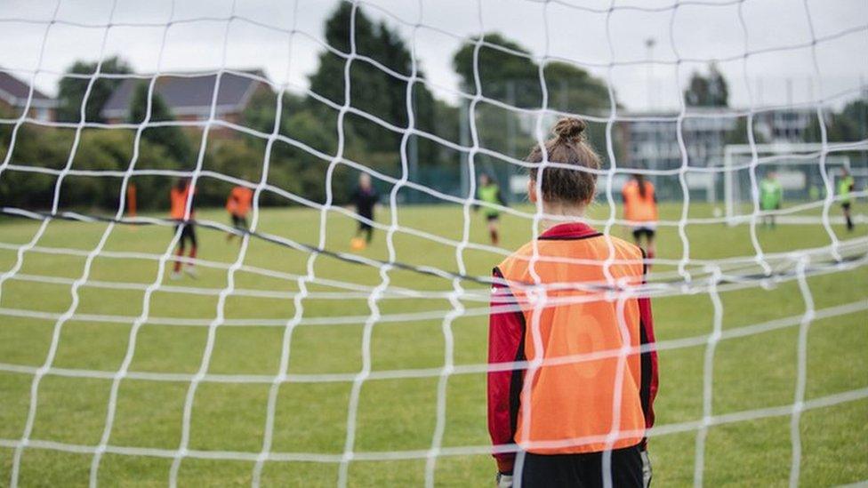 Anon girl stood in goal