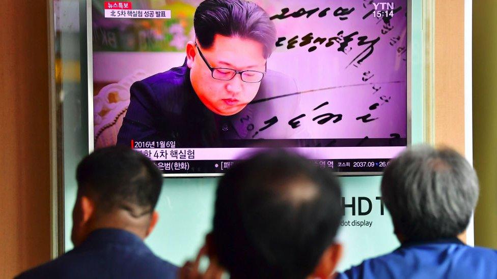 People watching a television news report, showing file footage of North Korean leader Kim Jong-un, at a railway station in Seoul. 9 Sept 2016