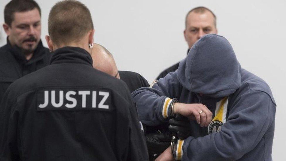 One of the suspects (right) enters the hearing room at the beginning of the trial in Dresden, Germany. Photo: 7 March 2017